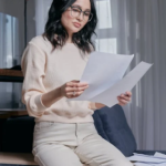 a woman holding two bondpaper