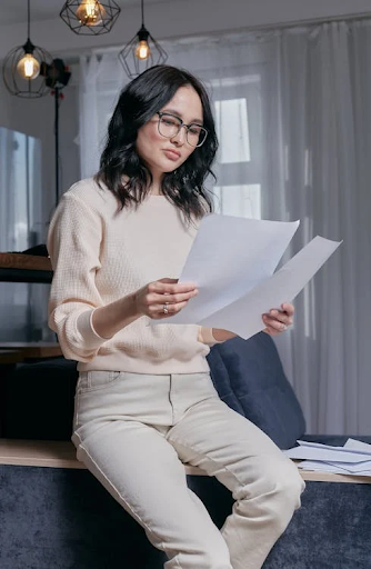 a woman holding two bondpaper